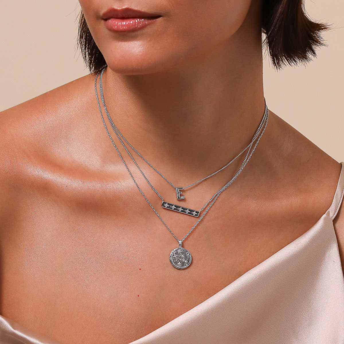 Taurus Zodiac Pendant Necklace in Silver worn layered with necklaces