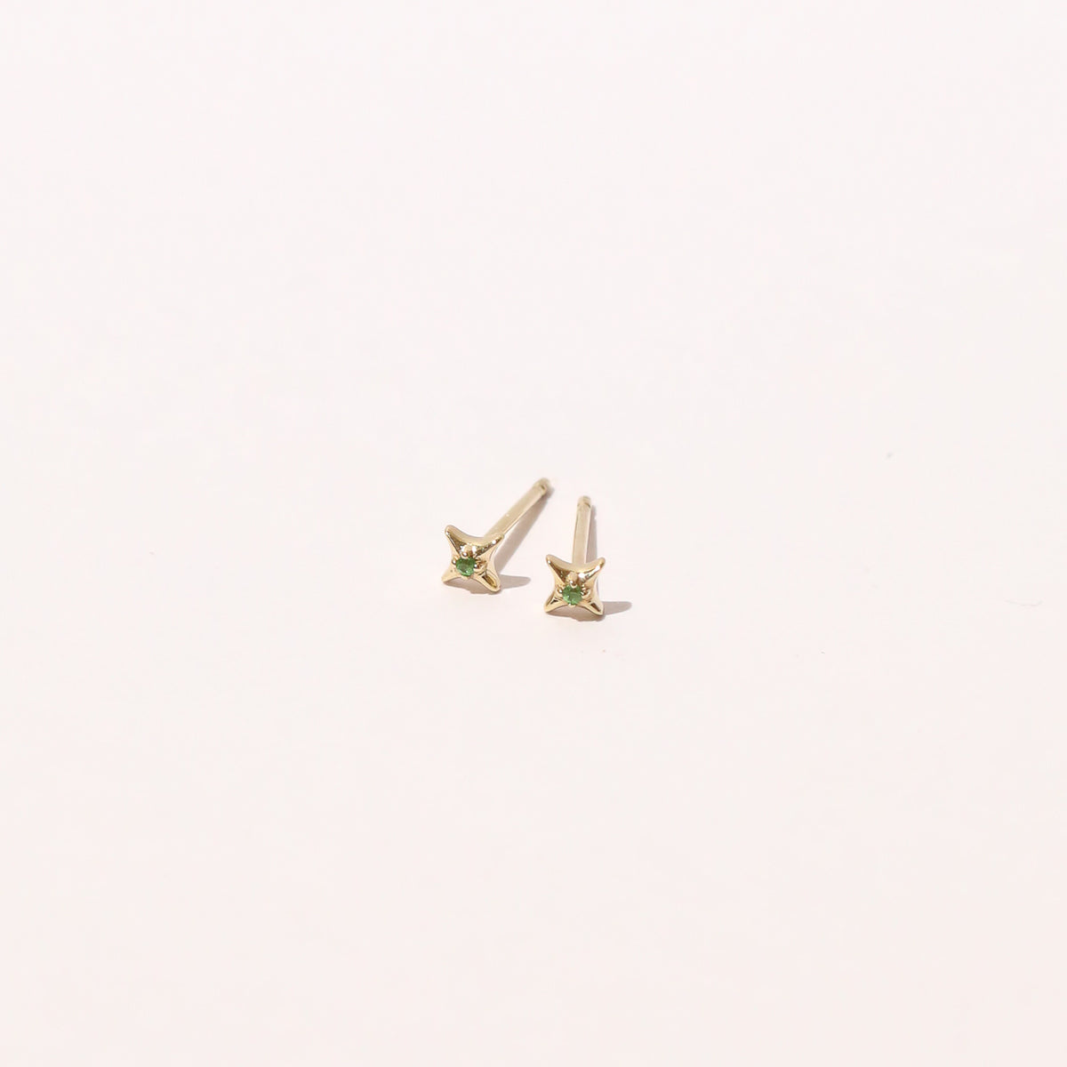 Tsavorite Stud Earrings in Solid Gold flat lay