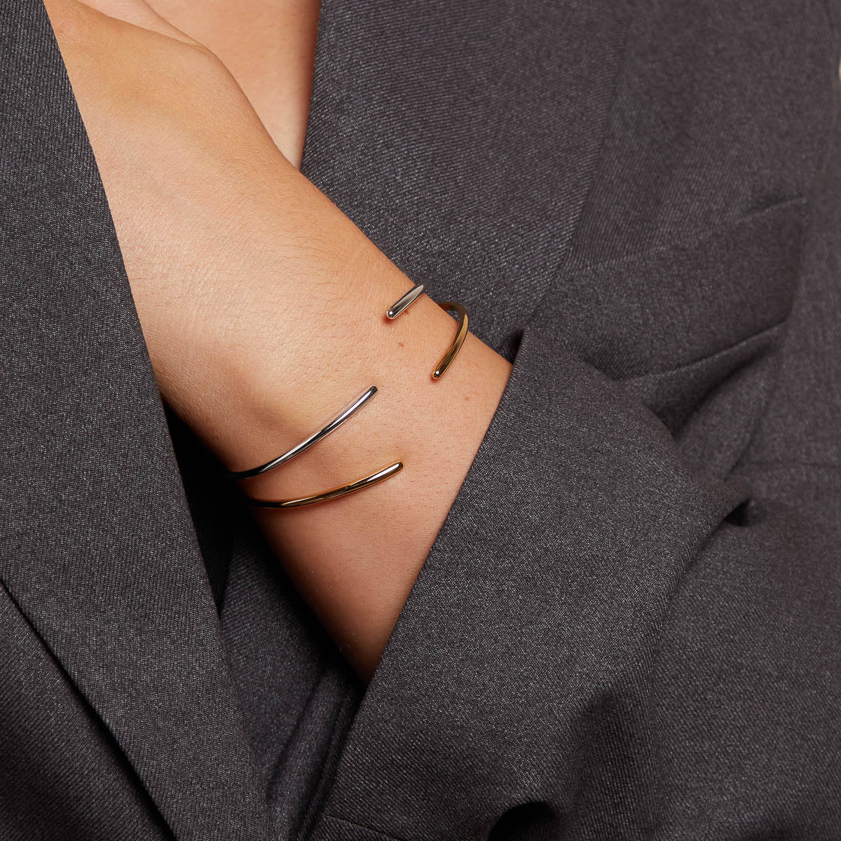 Twist Cuff in Gold worn with Twist Cuff in Silver