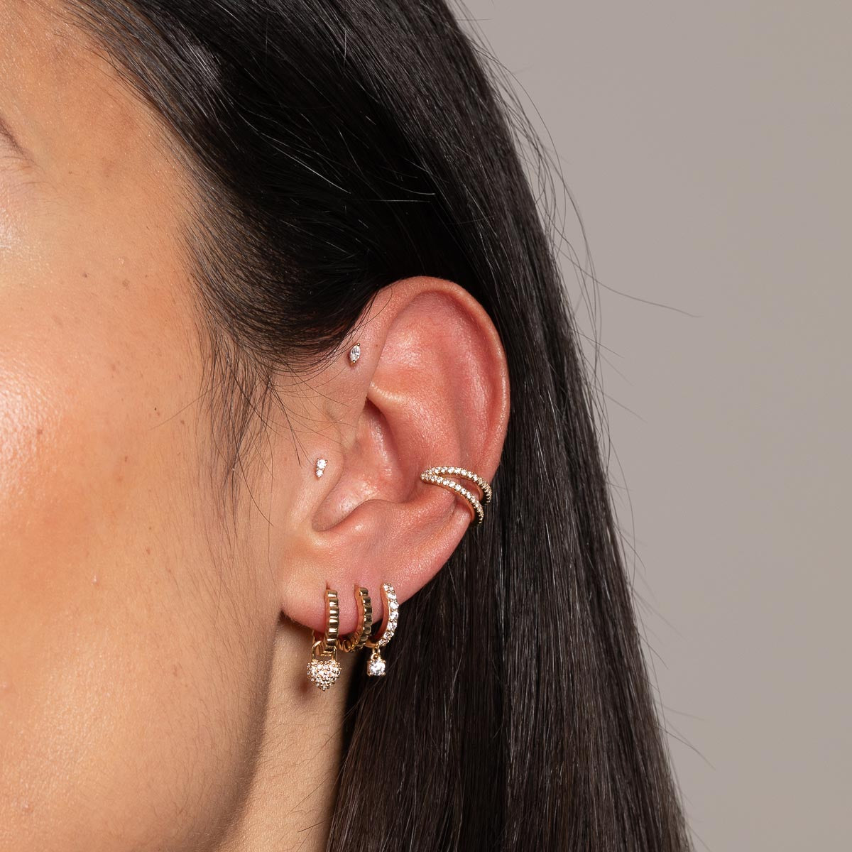 Charm Crystal Huggies in Gold worn with other earrings