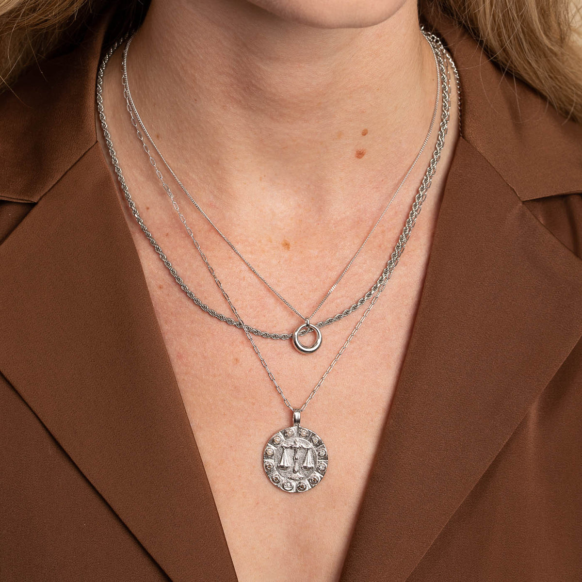 Libra Bold Zodiac Pendant Necklace in Silver worn layered with necklaces