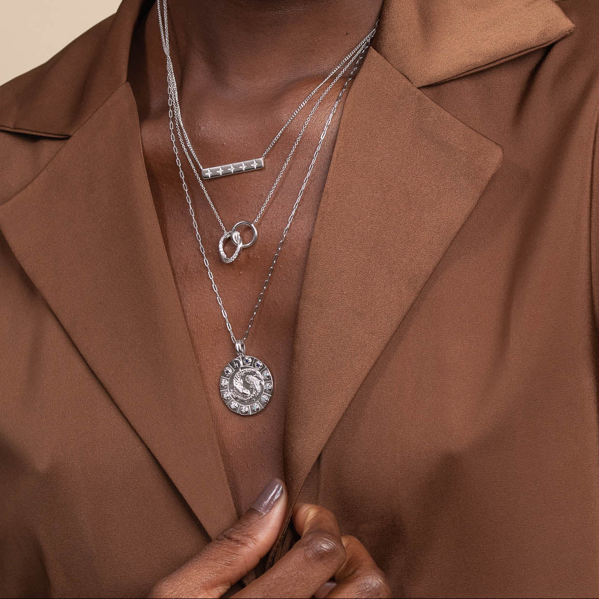Pisces Bold Zodiac Pendant Necklace in Silver worn layered with necklaces