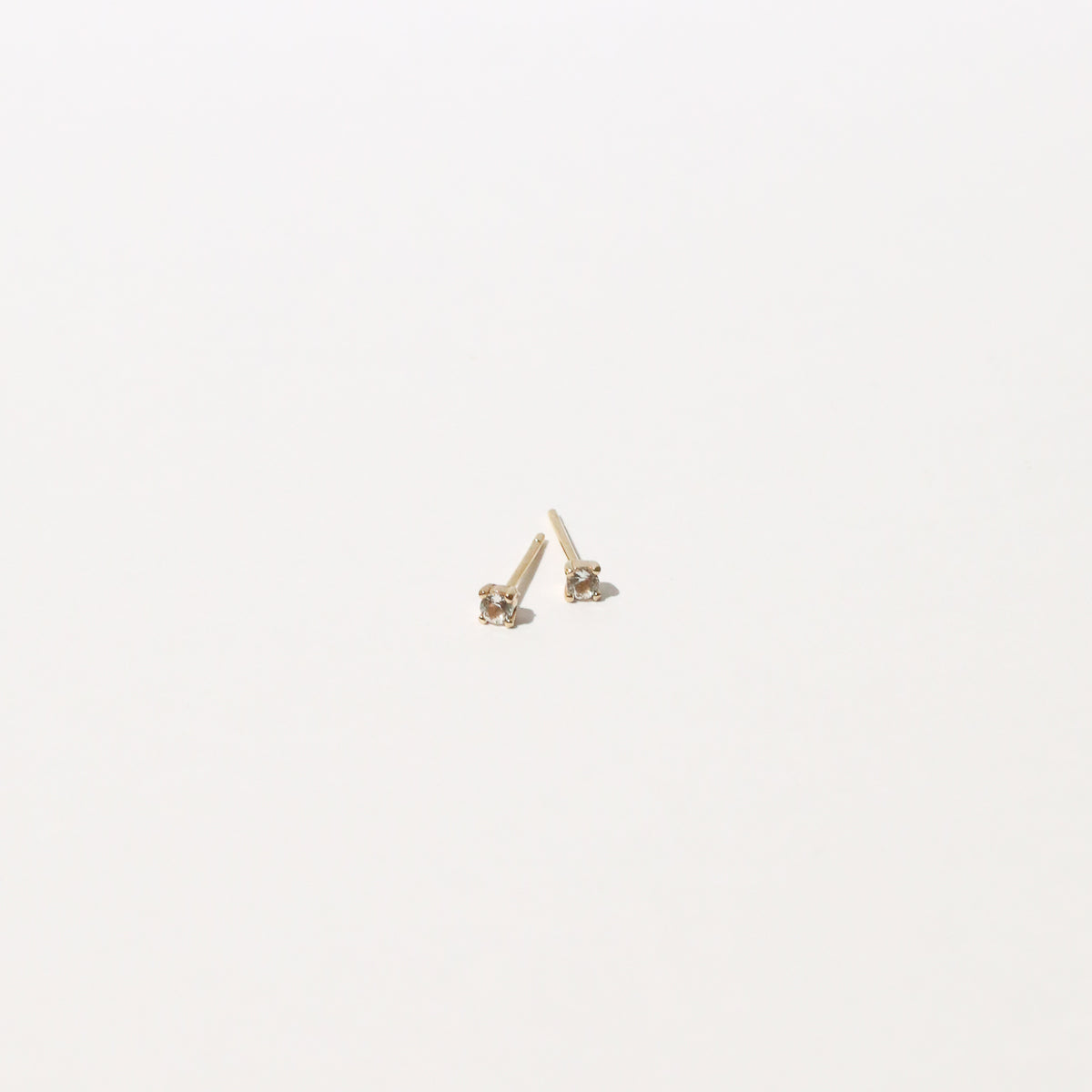 Topaz Stud Earrings in Solid Gold flat lay