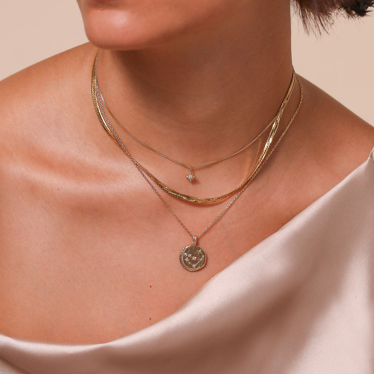 Capricorn Zodiac Pendant Necklace in Gold worn layered with necklaces