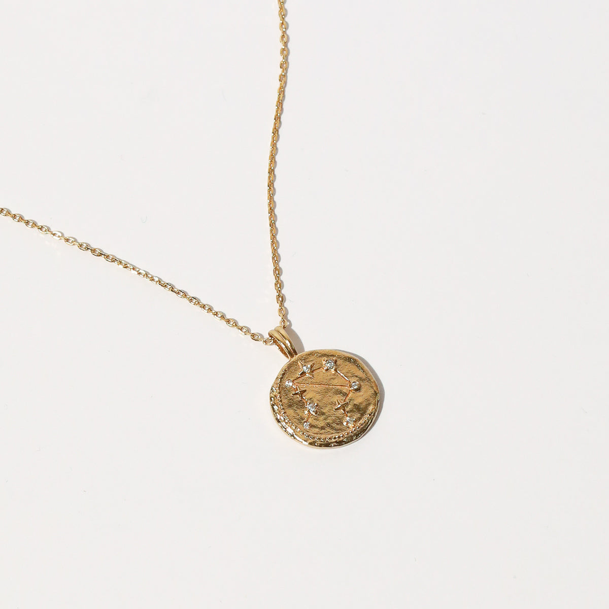 Close up shot of the front of the Libra Zodiac Pendant Necklace in Gold