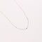 Topaz Charm Necklace in Solid Gold flat lay