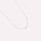 Topaz Charm Necklace in Solid White Gold flat lay