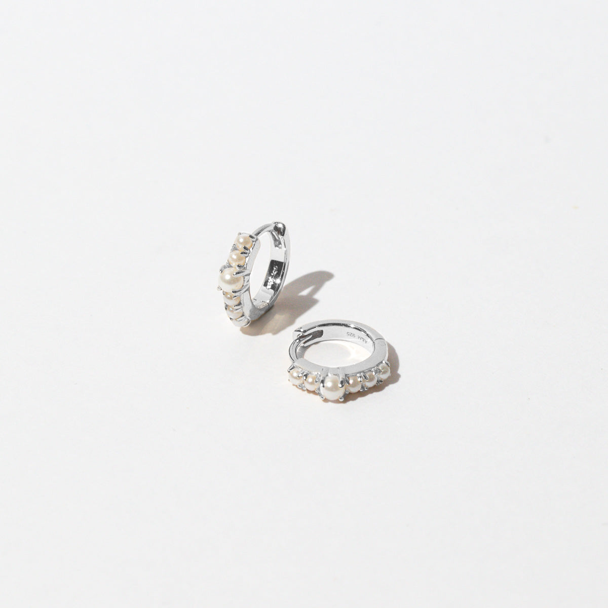 Radiant Pearl Huggies in Silver flat lay