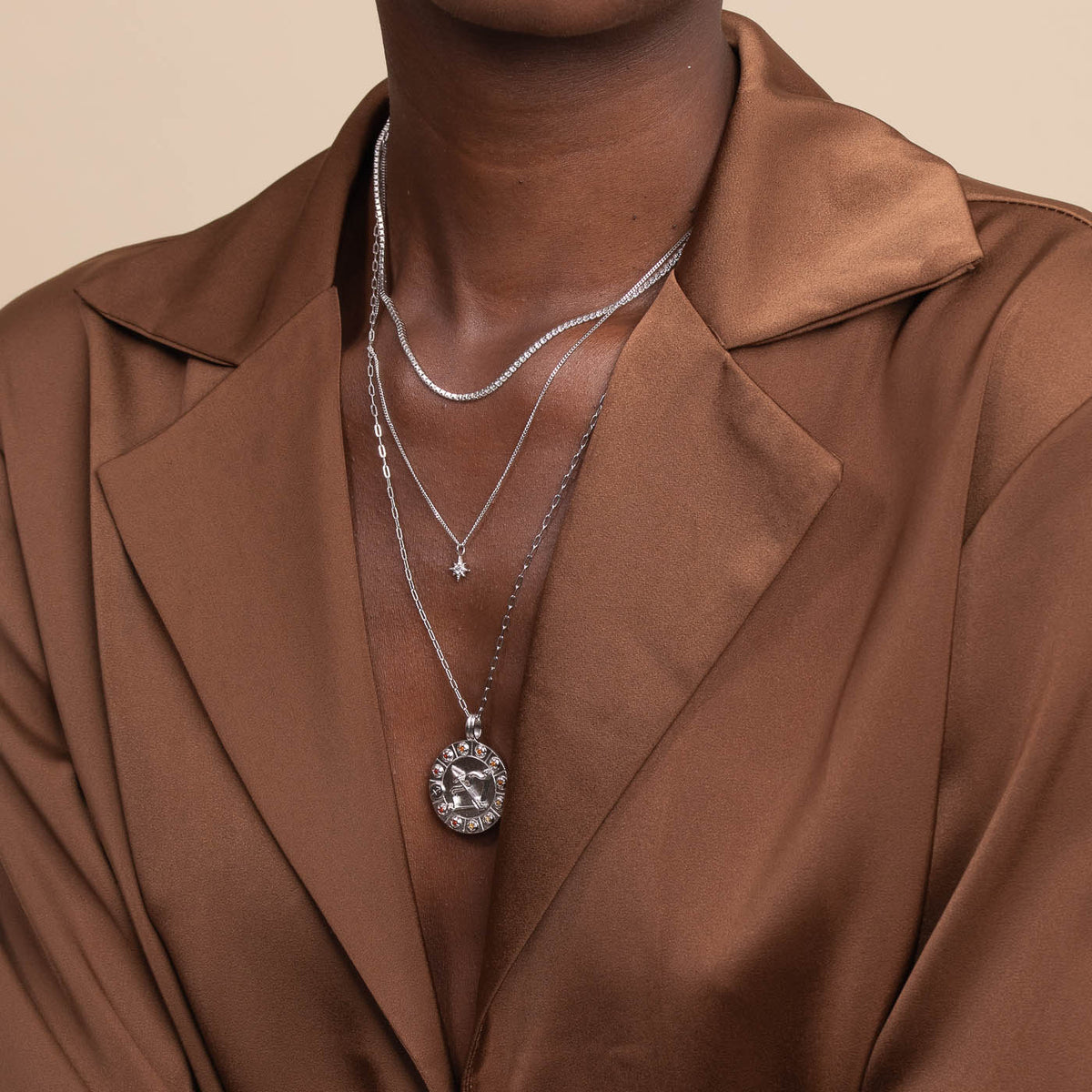 Sagittarius Bold Zodiac Pendant Necklace in Silver worn layered with necklaces