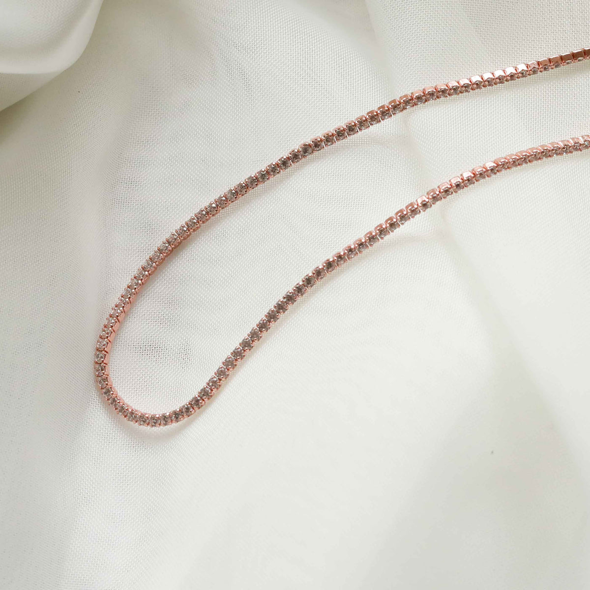 Flat lay shot of Tennis Chain Necklace in Rose Gold